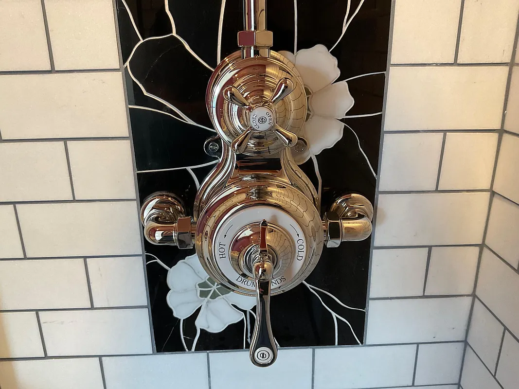bathroom with white subway tile and black and white decorative tile