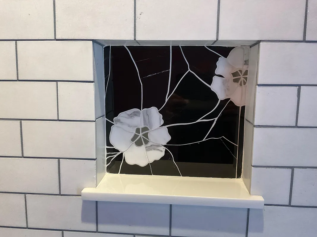bathroom with white subway tile and black and white decorative tile