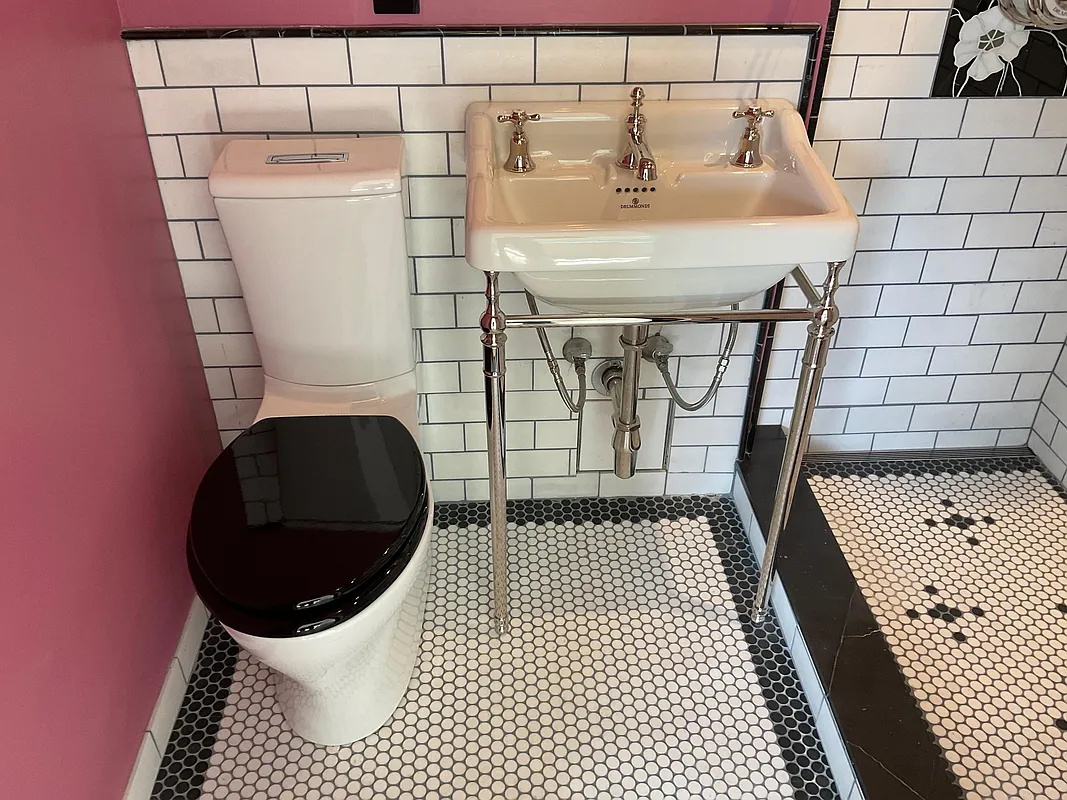 bathroom with white subway tile and white console sink