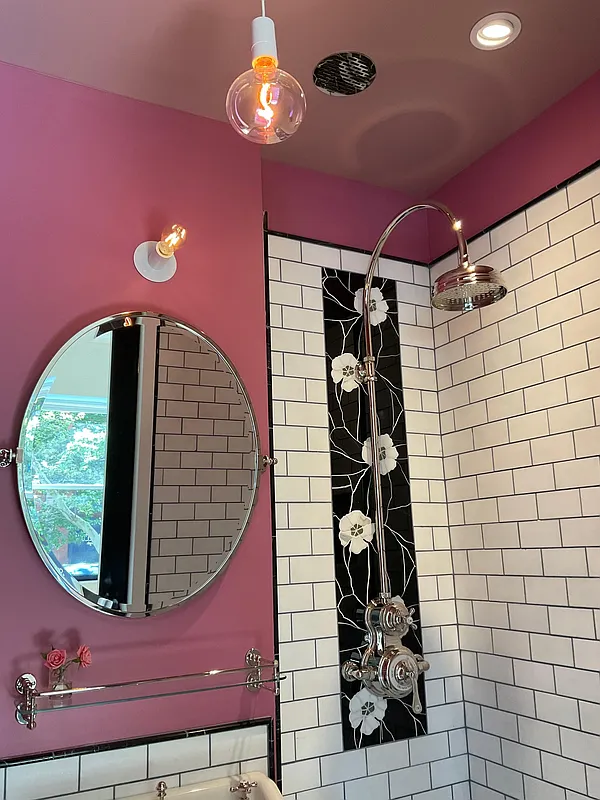 bathroom with white subway tile and black and white decorative tile