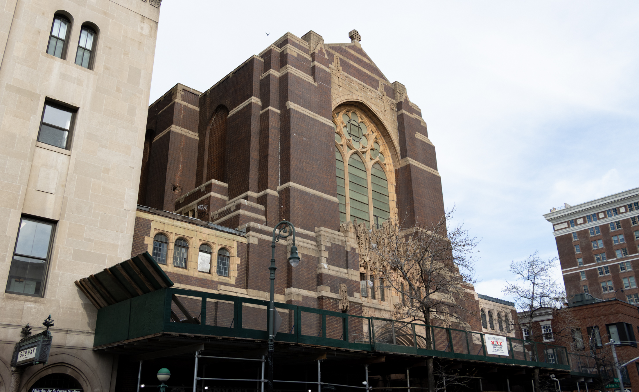 church with a sidewalk shed surrounding it