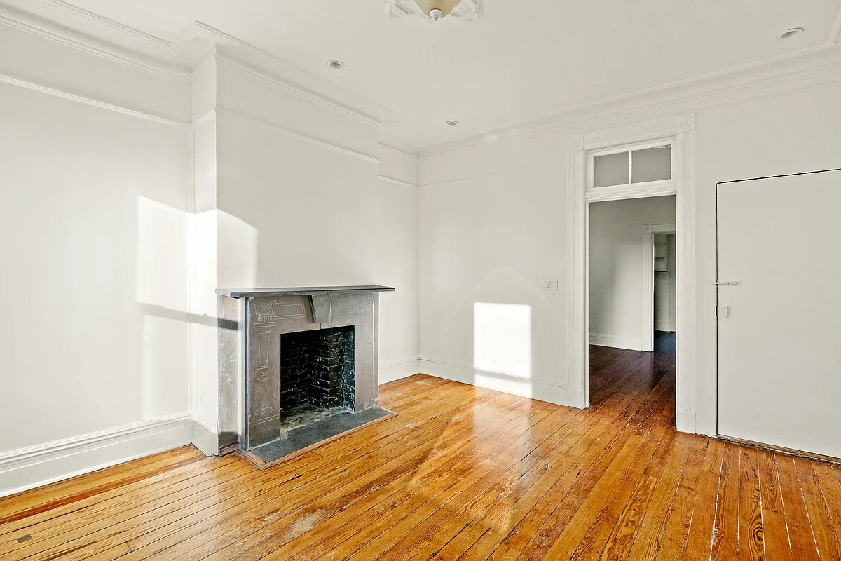 virtually staged living room with mantel, wood floor