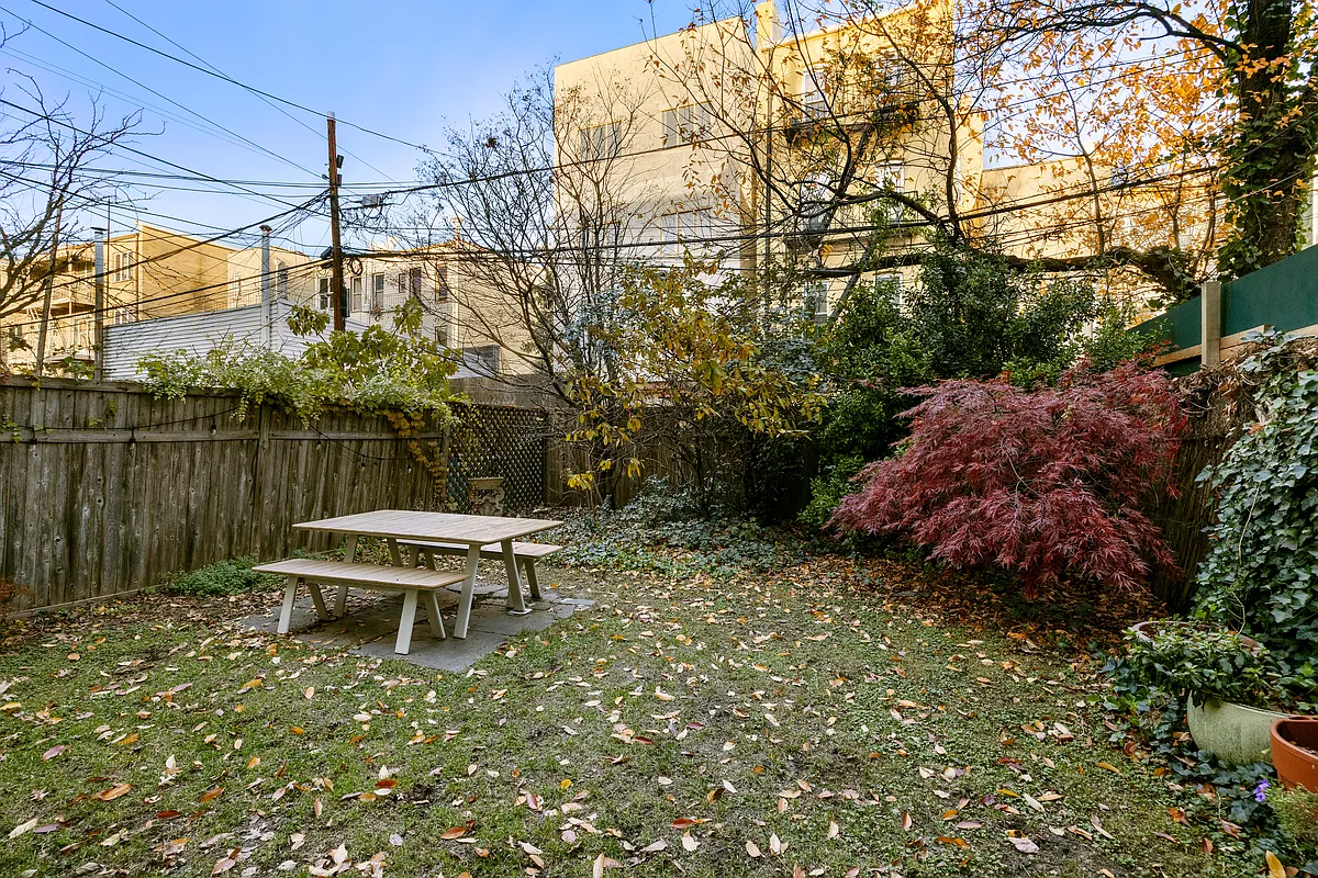 yard with a picnic table and trees and shrubs