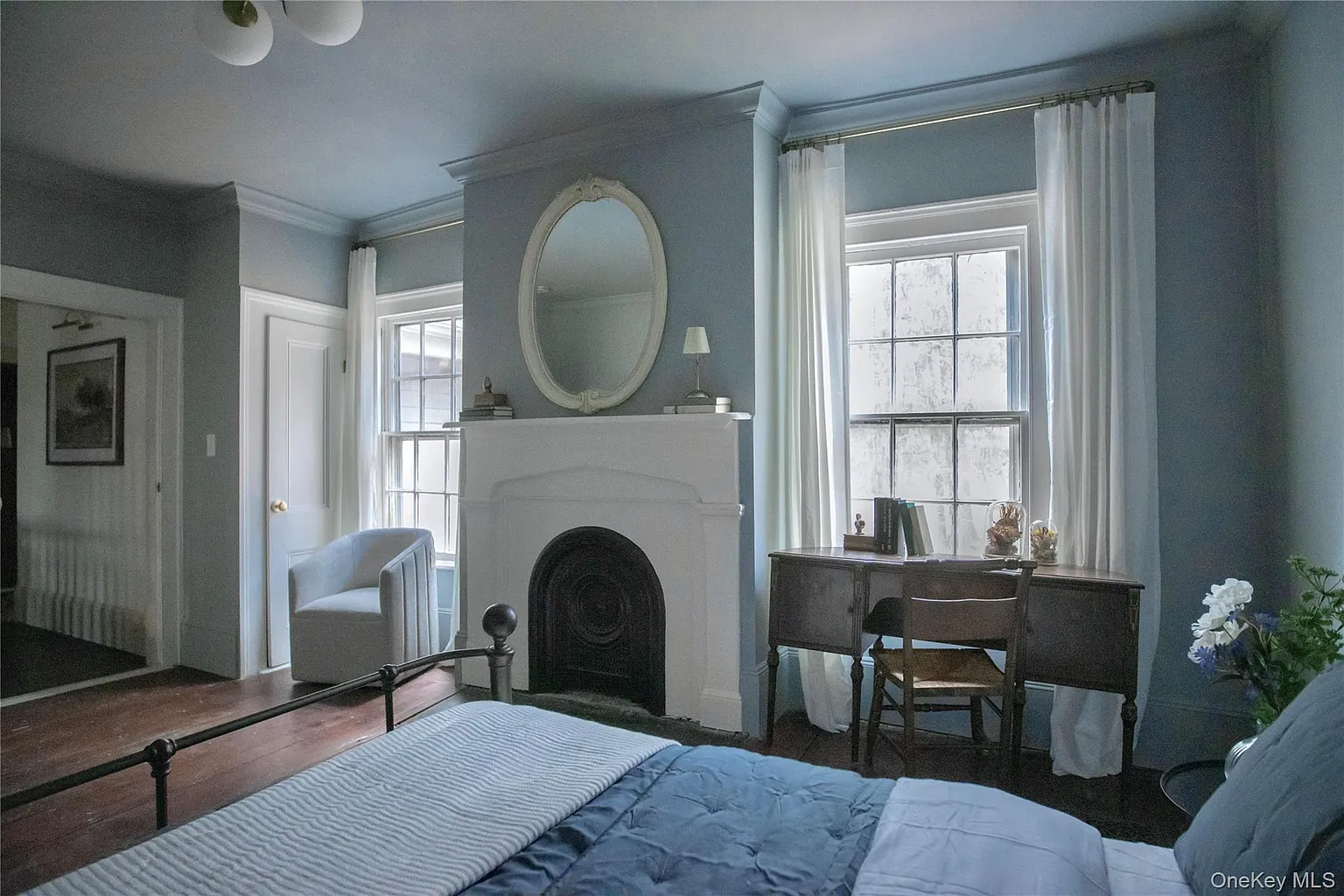 bedroom with blue walls, marble mantel