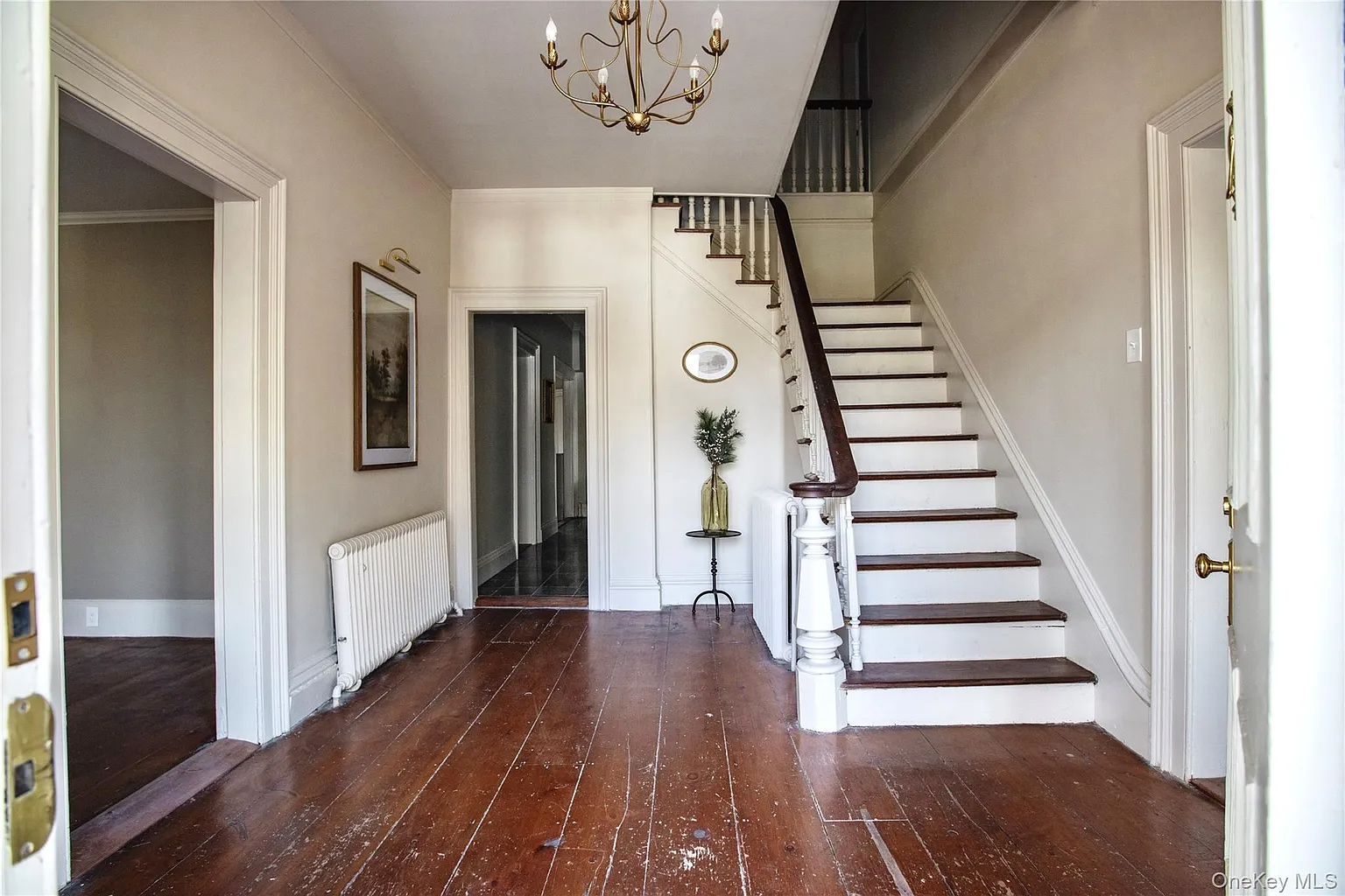 entry with stair, wide plank wood floors
