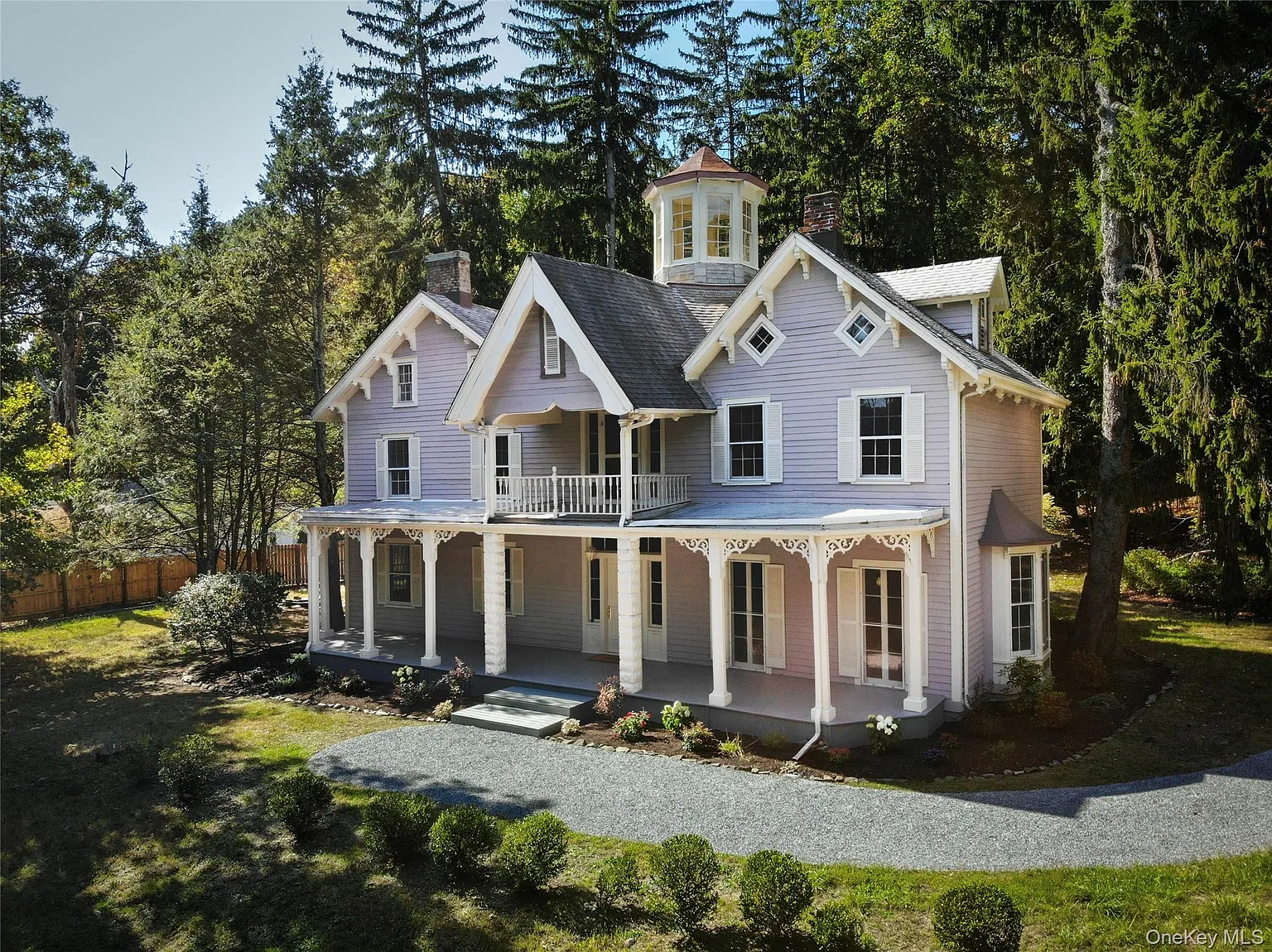 blue clapboard house with a tower