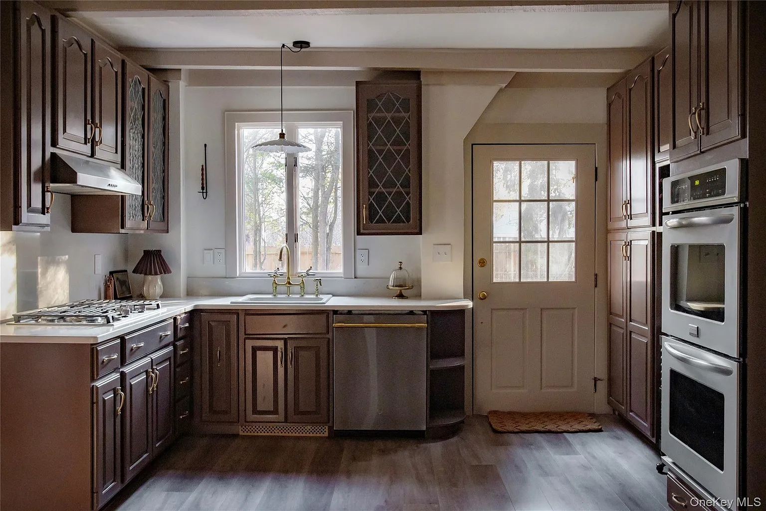 kitchen with brown cabinets, door to outside
