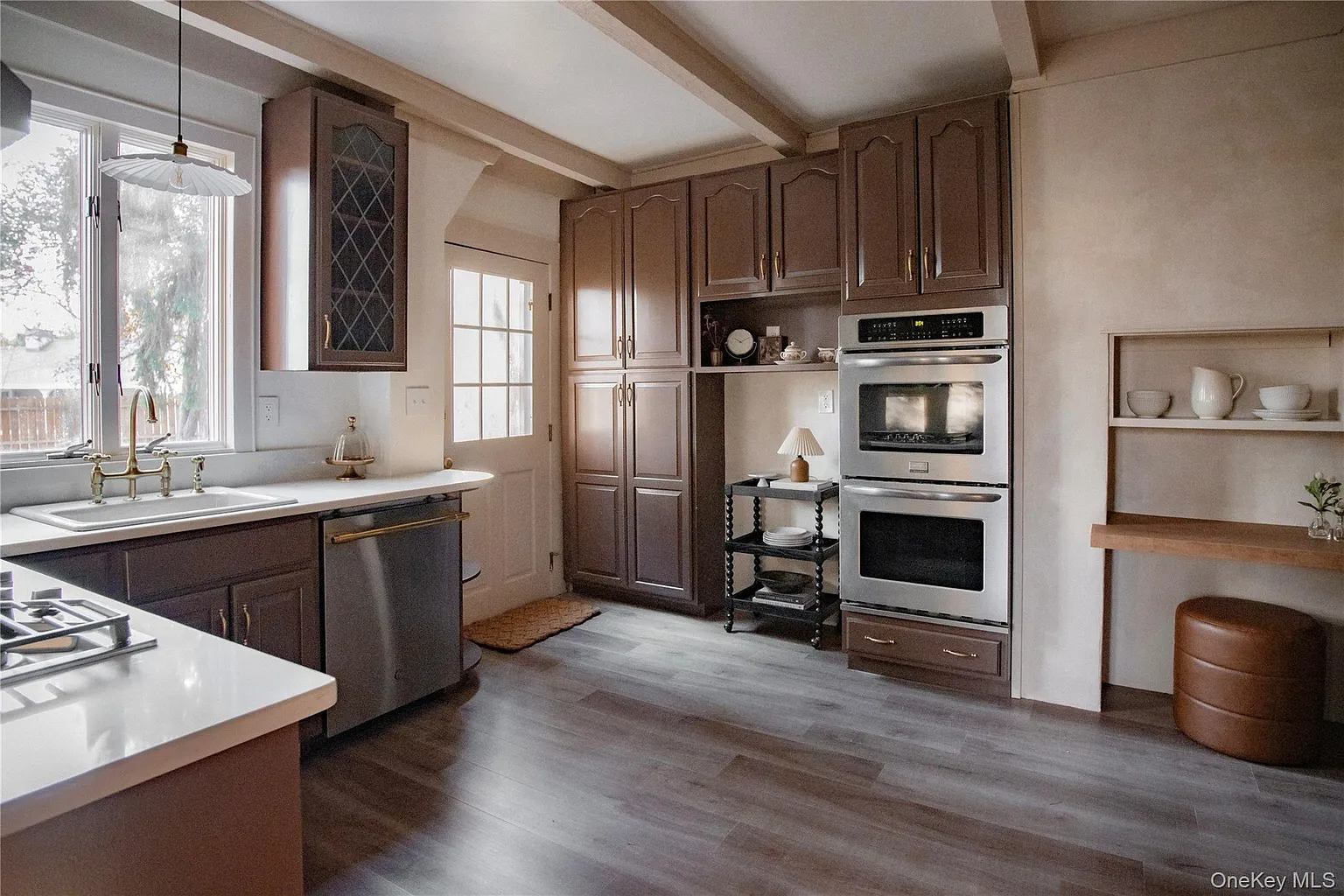 kitchen with brown cabinets, faux wood floor