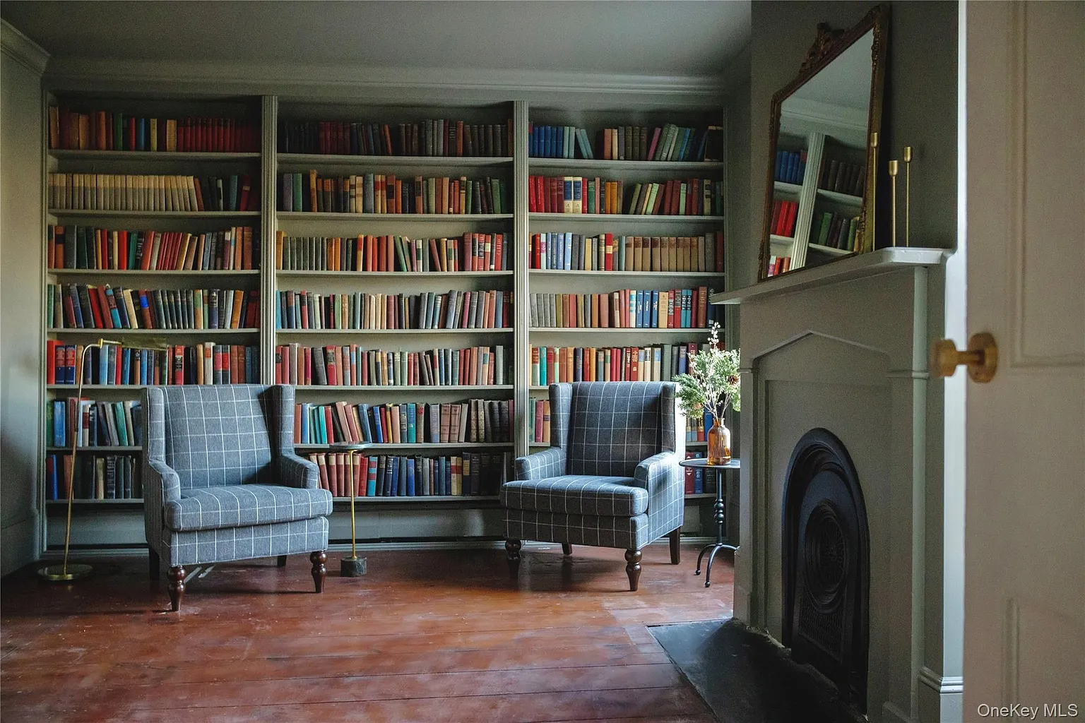 library with marble mantel, bookshelves