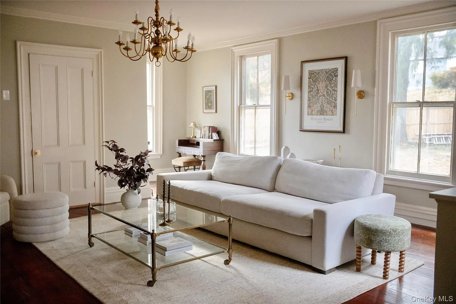 living room with white walls, wood floor