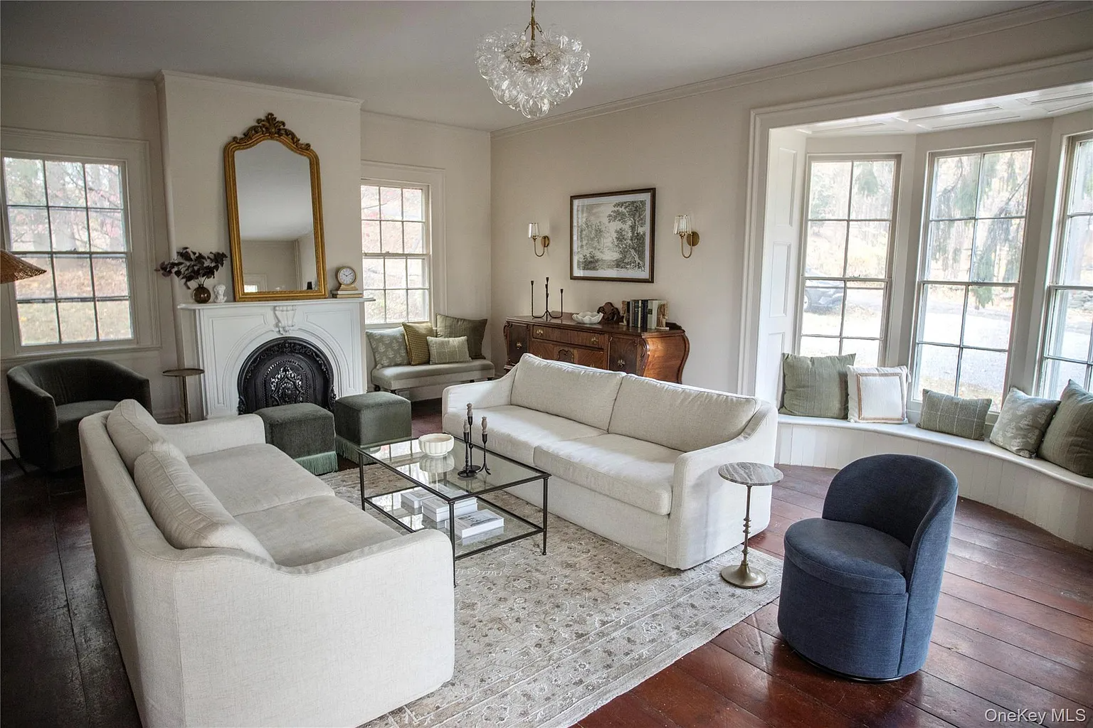 parlor with wood floors, marble mantel