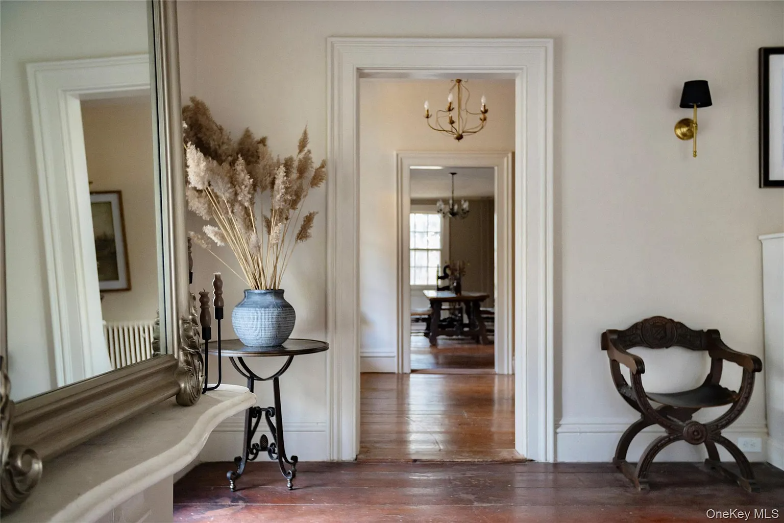 parlor with view into the hall with wood floors