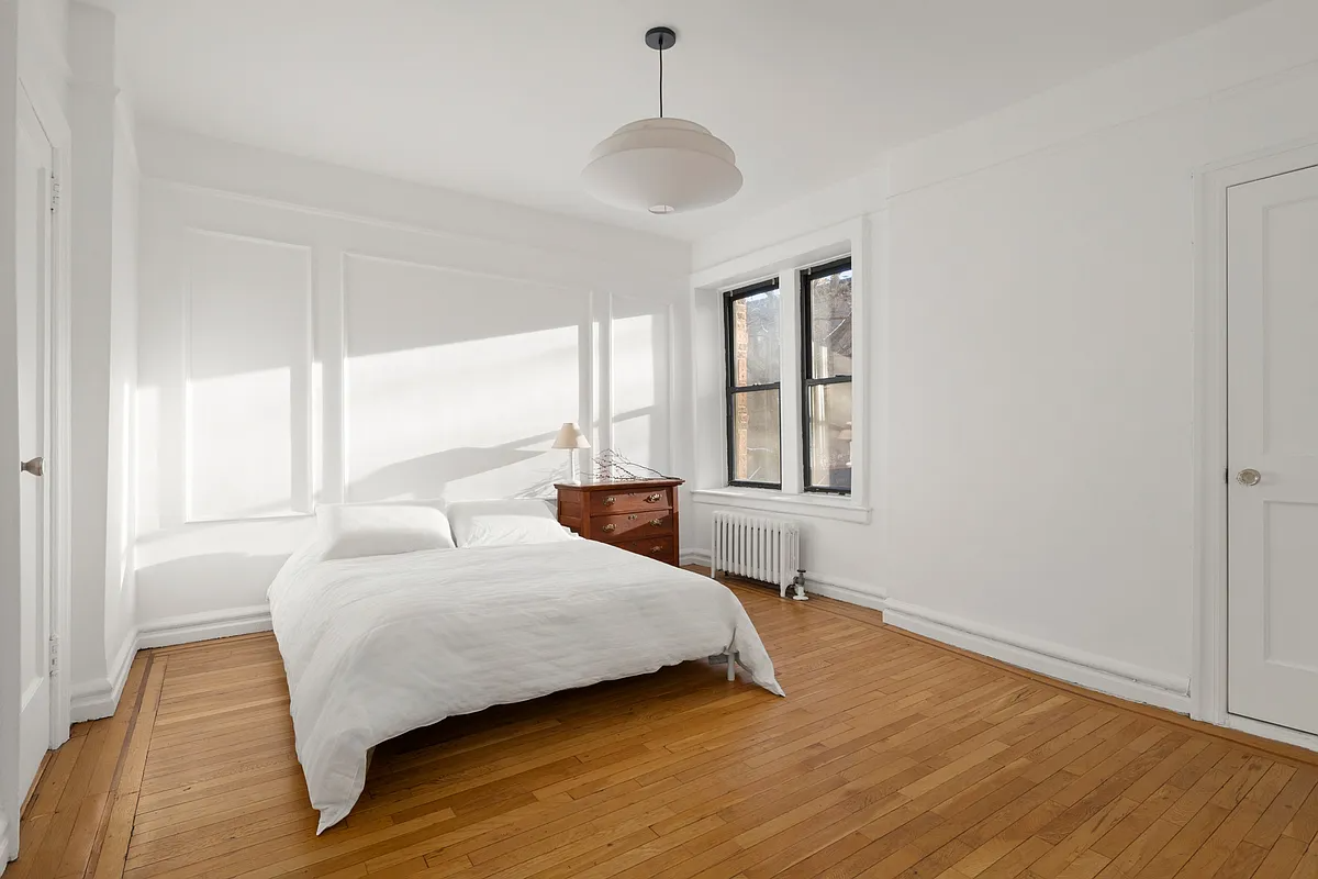 bedroom with wall moldings, picture rails