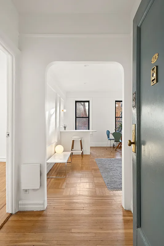 foyer with wood floor, arched doorway