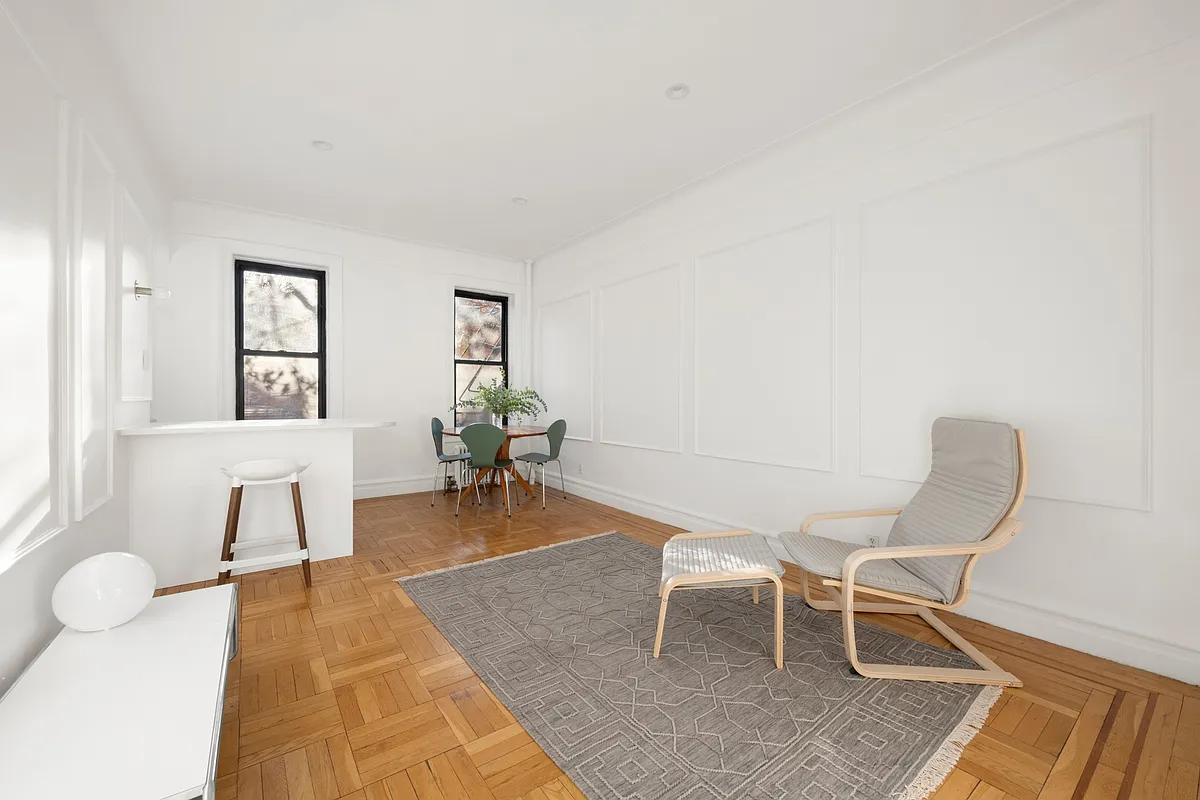 living room with wood floor, wall molidngs