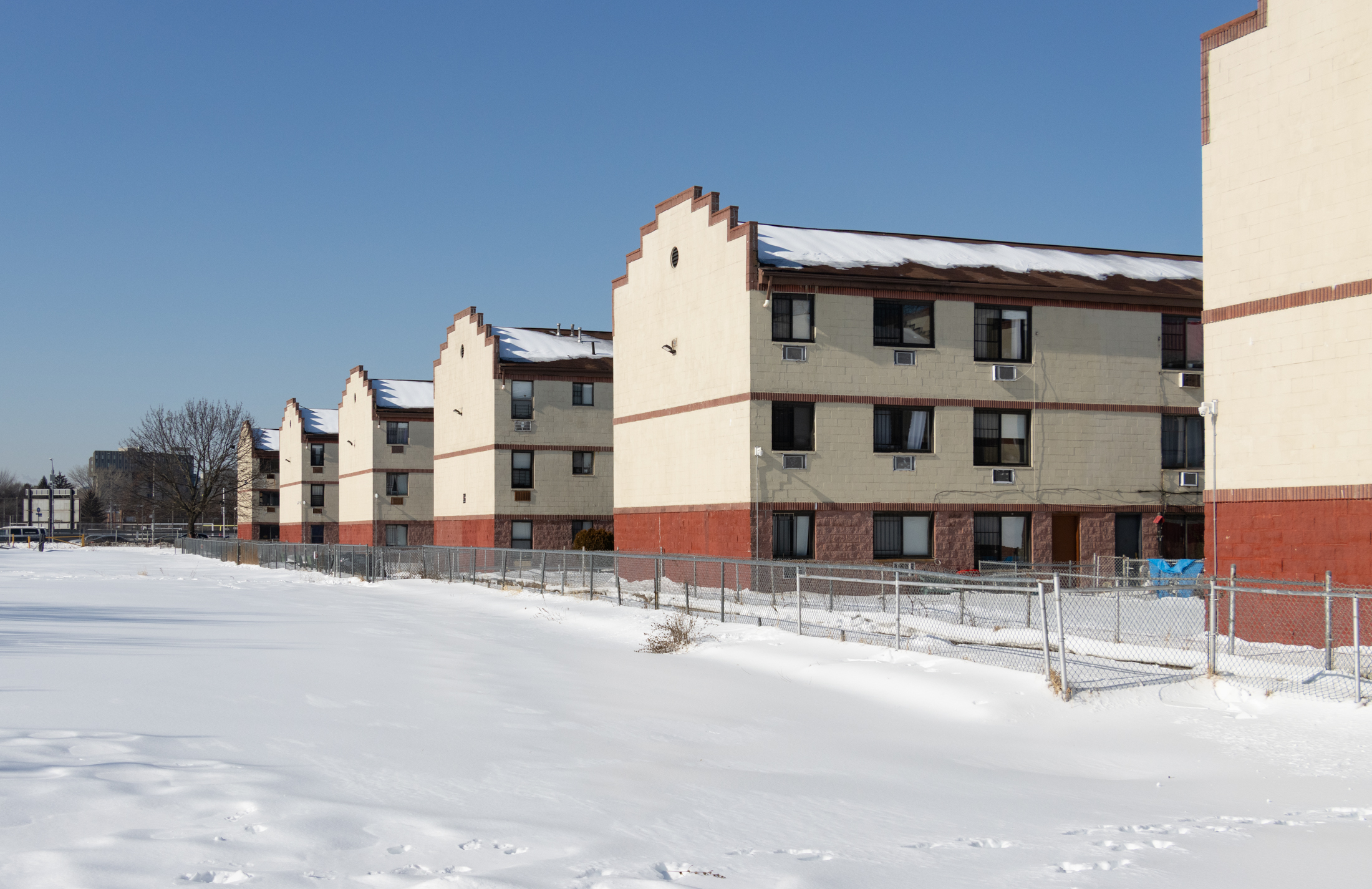 low scale housing and a snow covered parking lot viewed from hunterfly place
