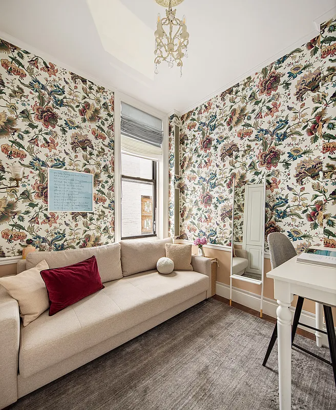 bedroom with large floral wallpaper set up as an office