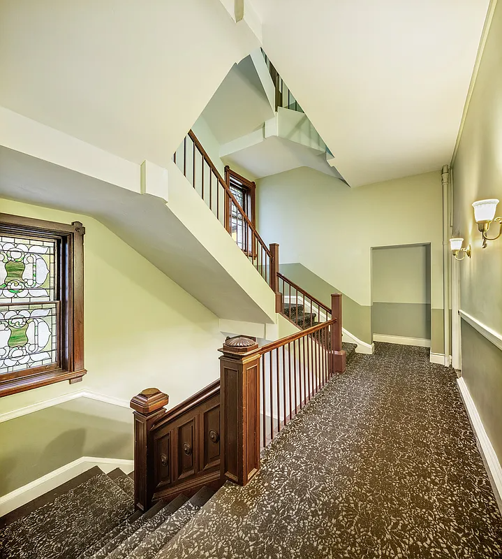 building hallway with carpet, stained glass window
