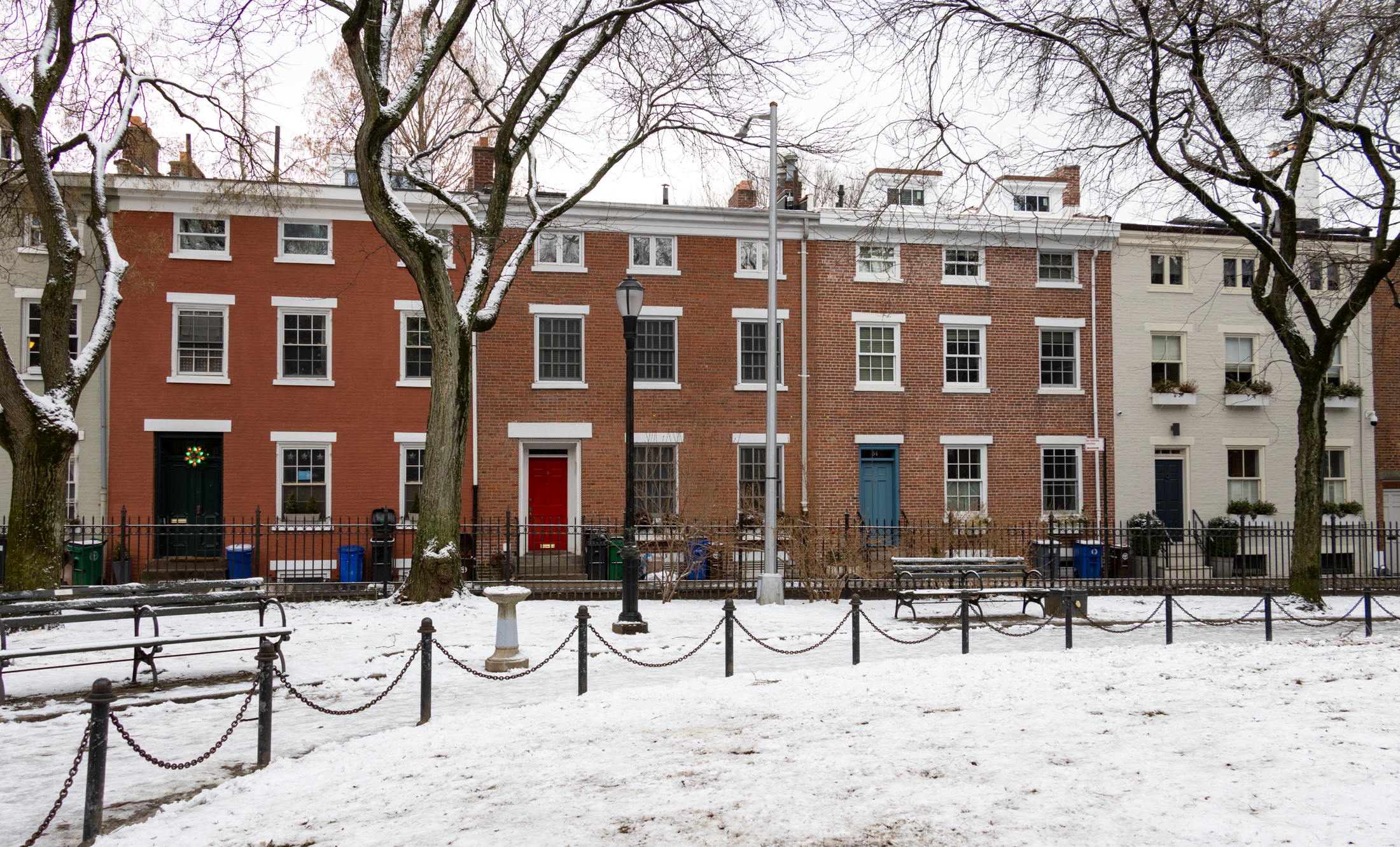 snowy cobble hill park with row houses