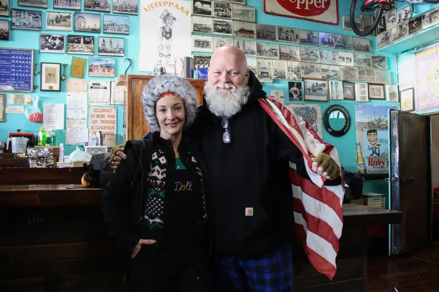 two people posing inside a building