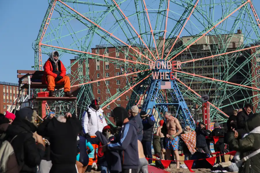 people in front of the wonder wheel