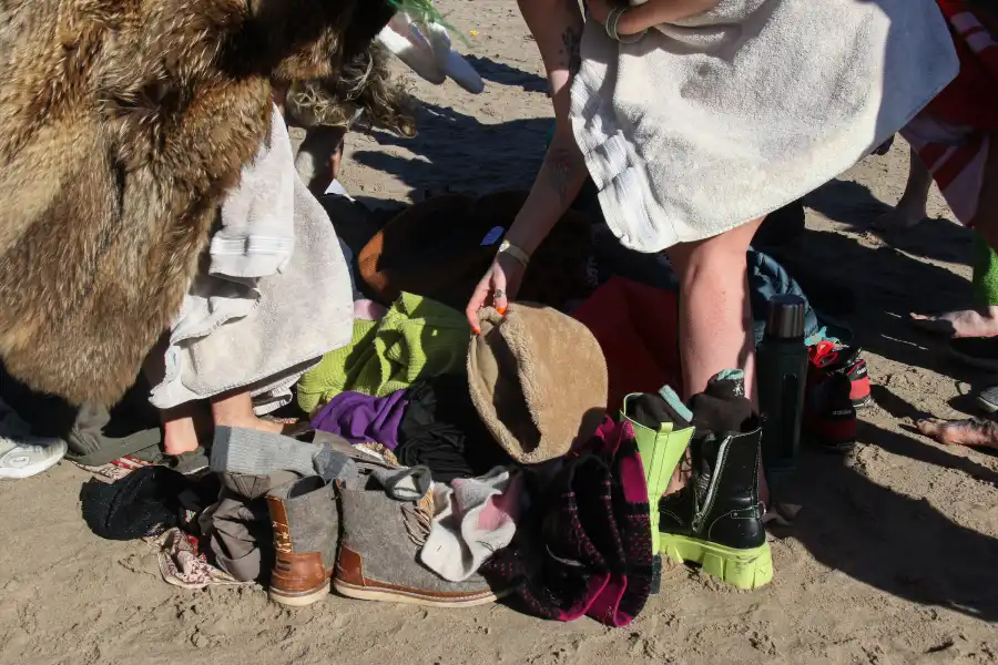 people grabbing warm clothing