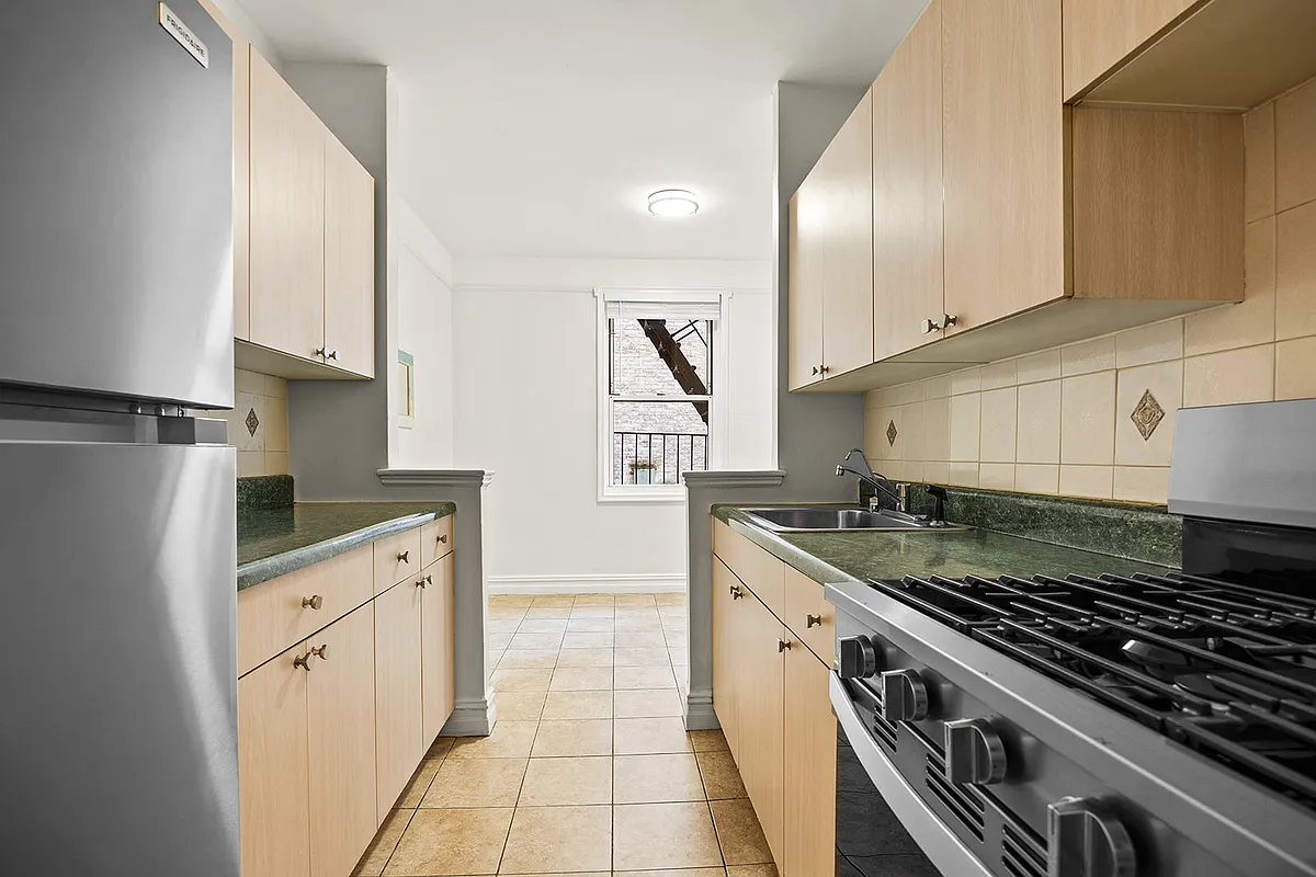 kitchen with tile floor, slab front cabinets