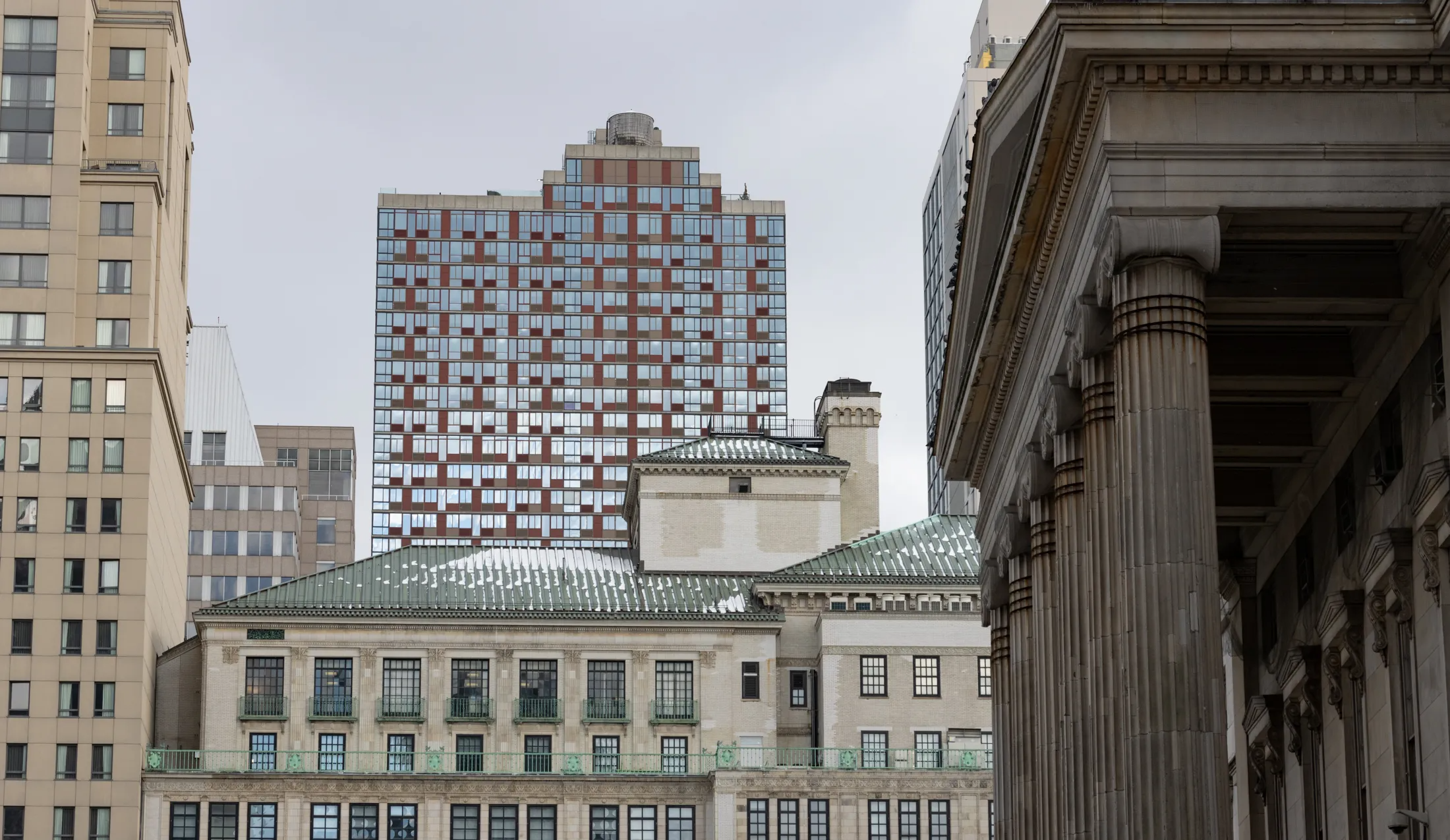 columns of borough hall with a snowy roof in the distance