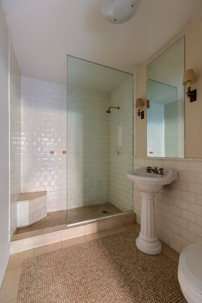 bathroom with walk-in shower, pedestal sink