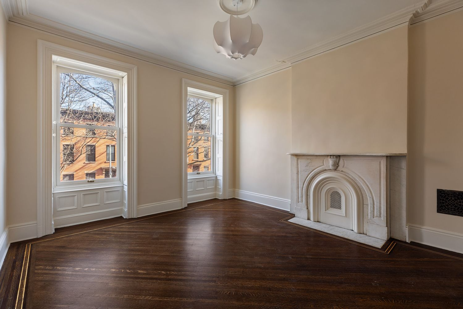 bedroom with marble mantel, two windows