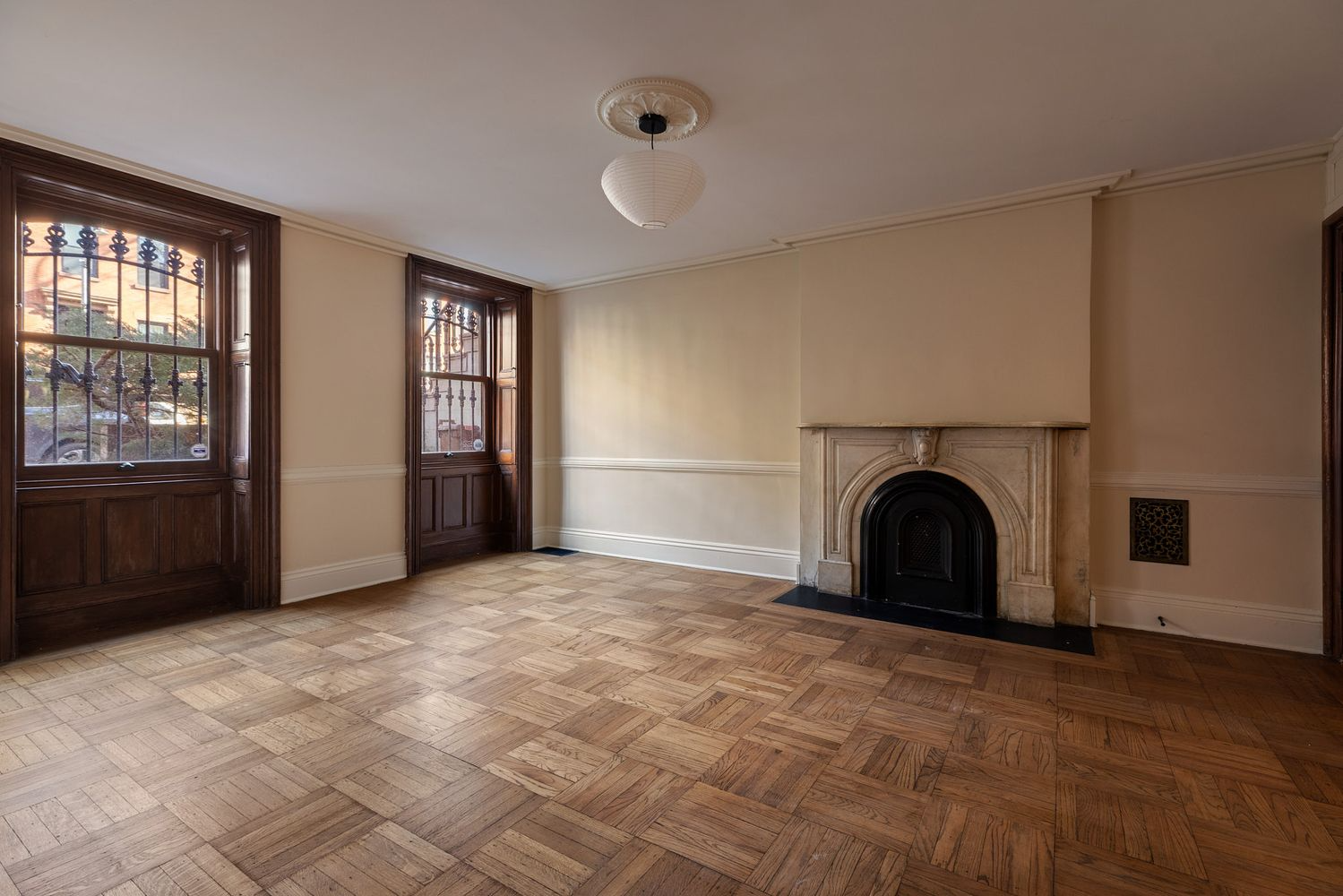 garden level room with mantel, two windows