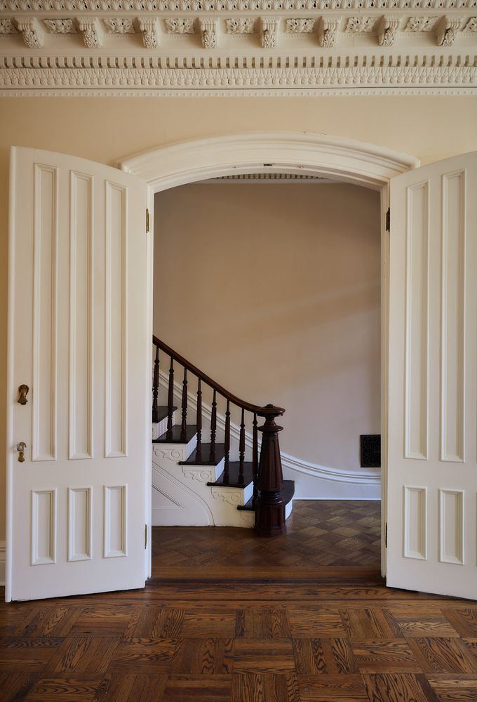 view from parlor to entry hall with stair and newel post
