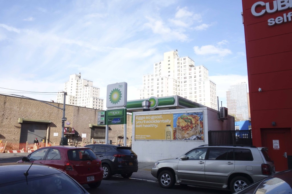 gas station with cars in foreground