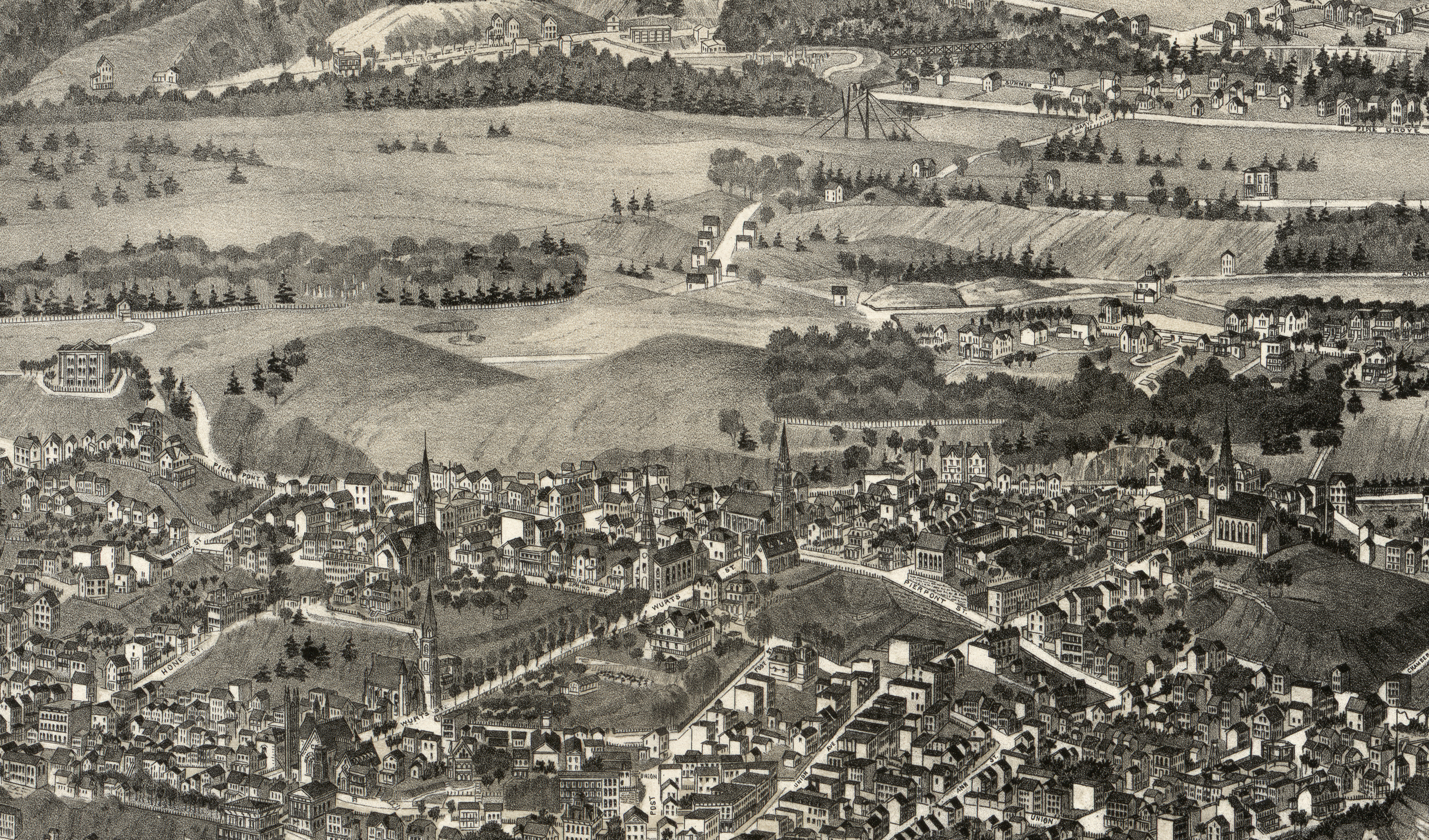 aerial view showing streets and houses and empty hills