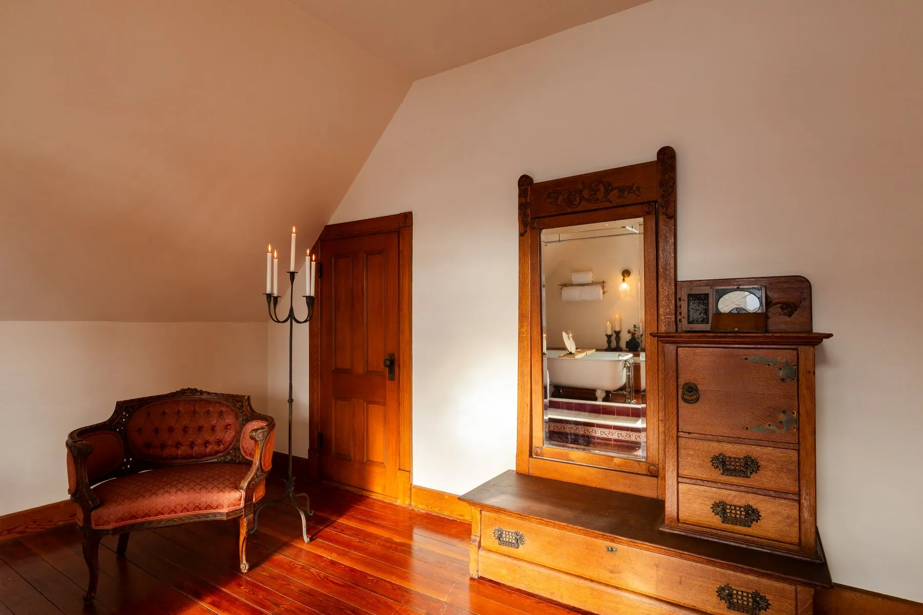 bedroom with angled ceiling, wood floor