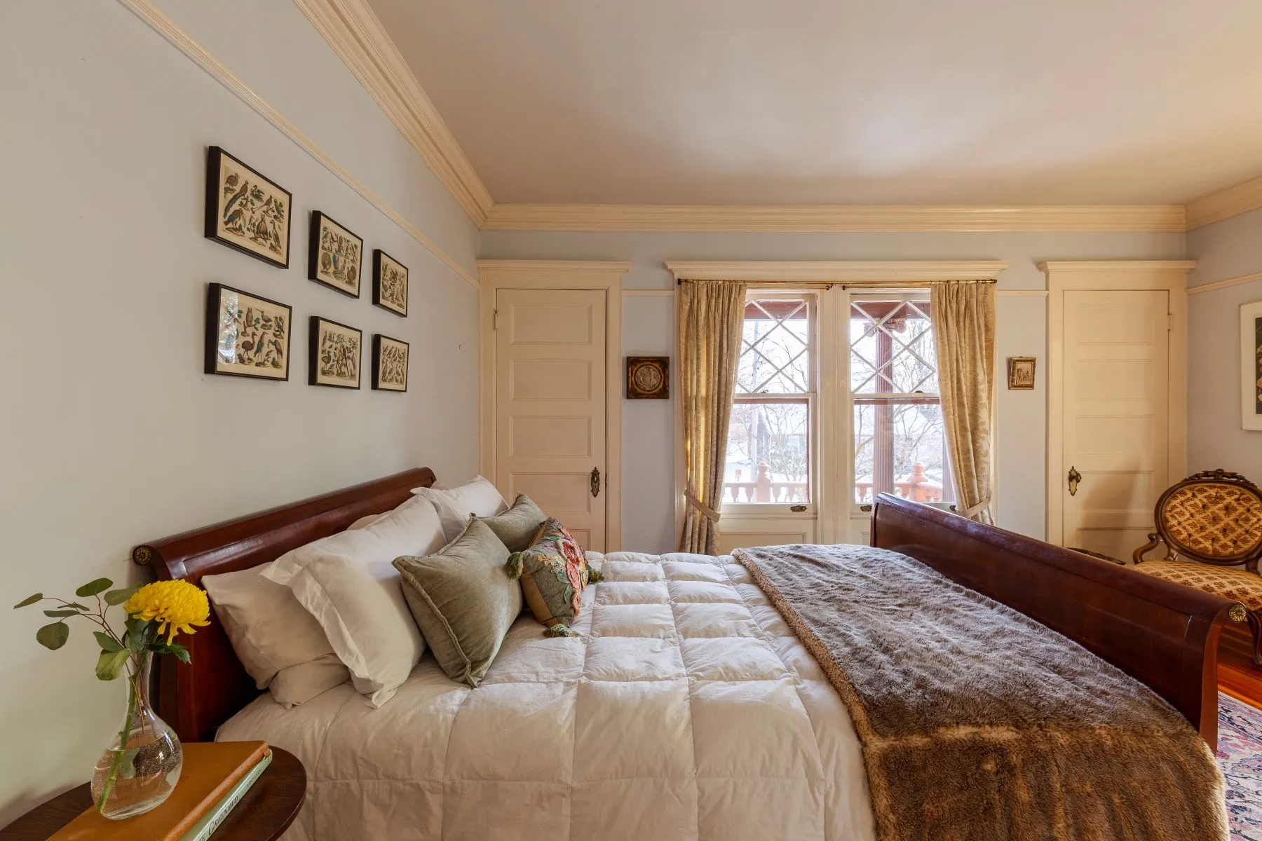 bedroom with picture rails, windows out to a porch