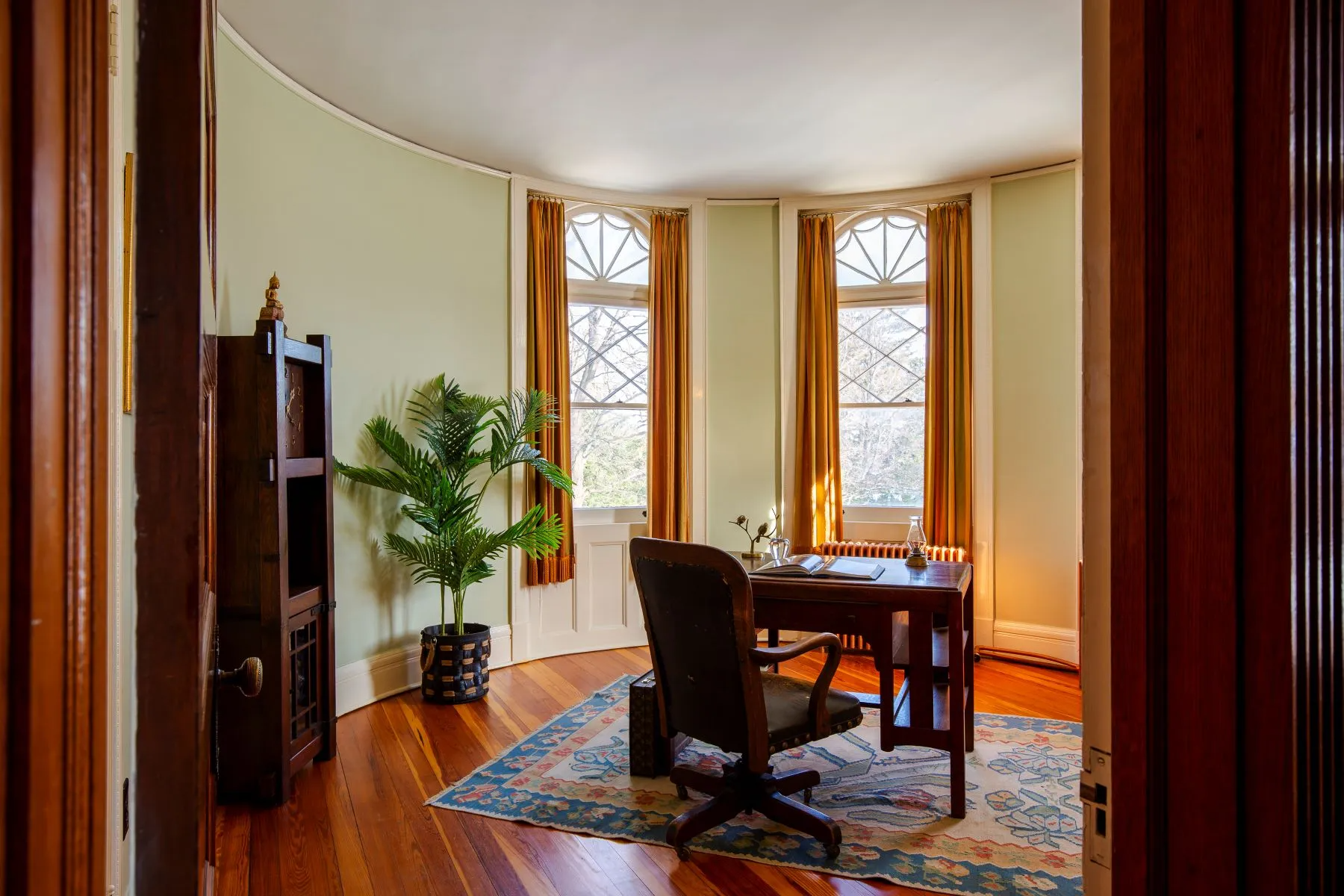 bedroom with rounded bay set up as an office