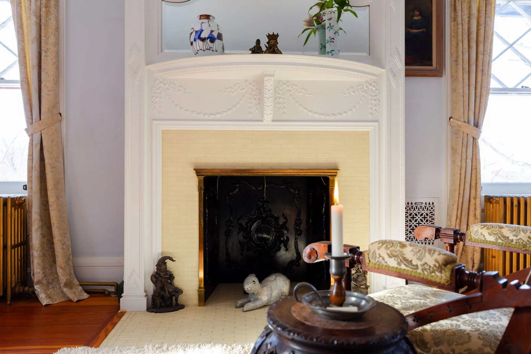 bedroom with a white mantel with tile surround