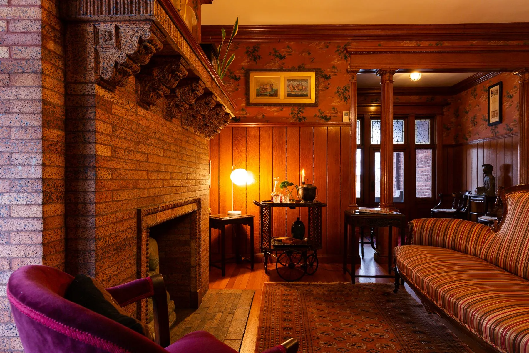 hall seating area with mantel, wainscoting