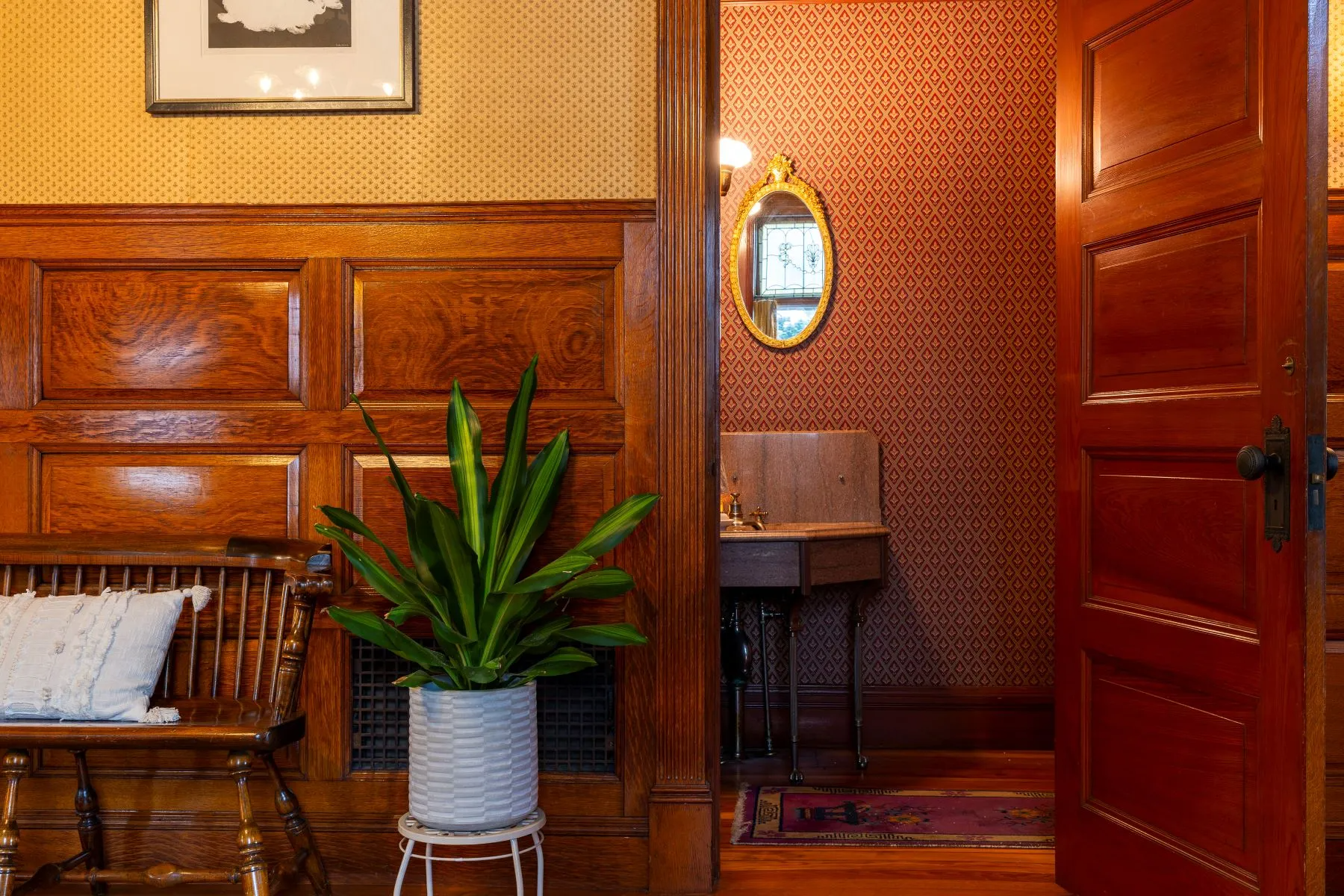 view into bathroom with wallpaper