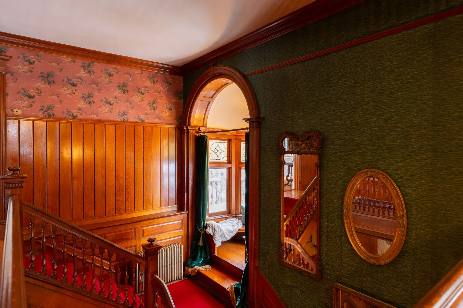 stair landing with steps up to a curved window seat