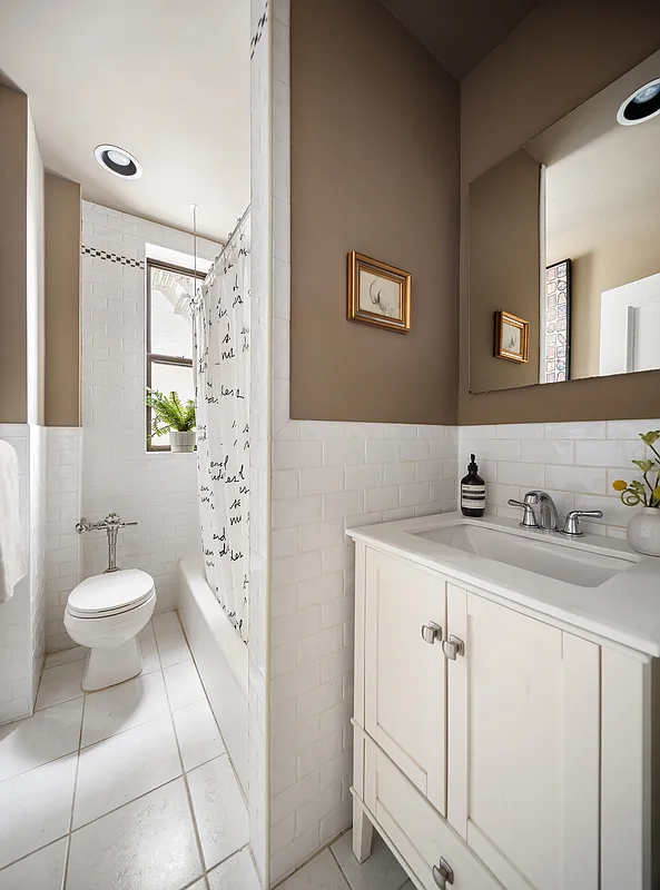 bathroom with white fixtures, tile