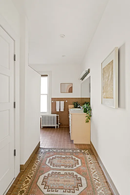 bathroom with tile floor and beige vanity