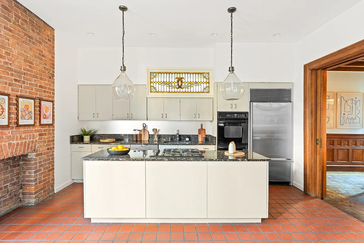 kitchen with terra cotta tile floor, cream cabinets