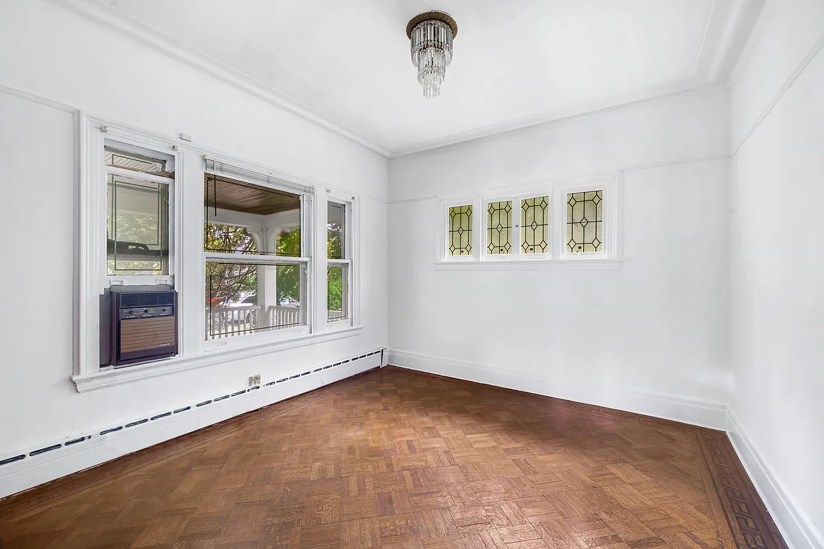 small parlor with white walls, wood floor