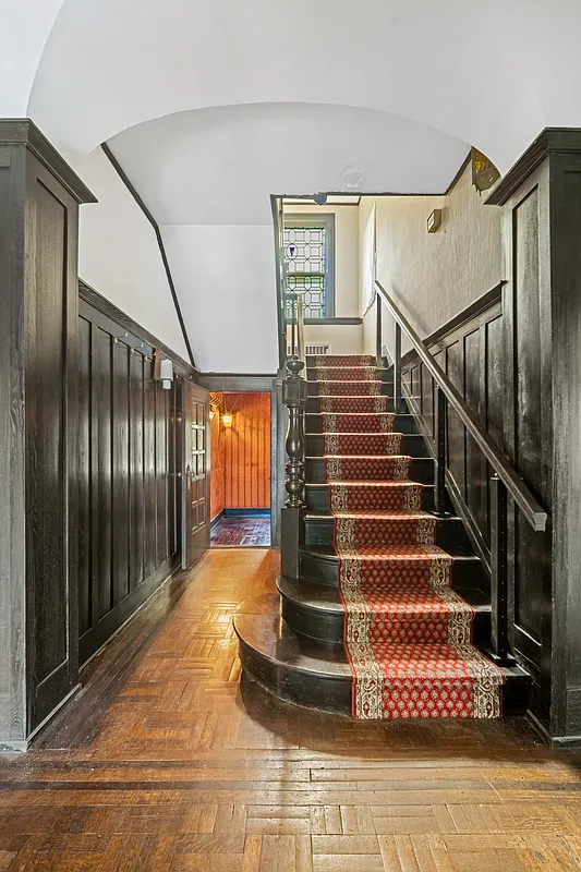 stair hall with wainscoting, newel post
