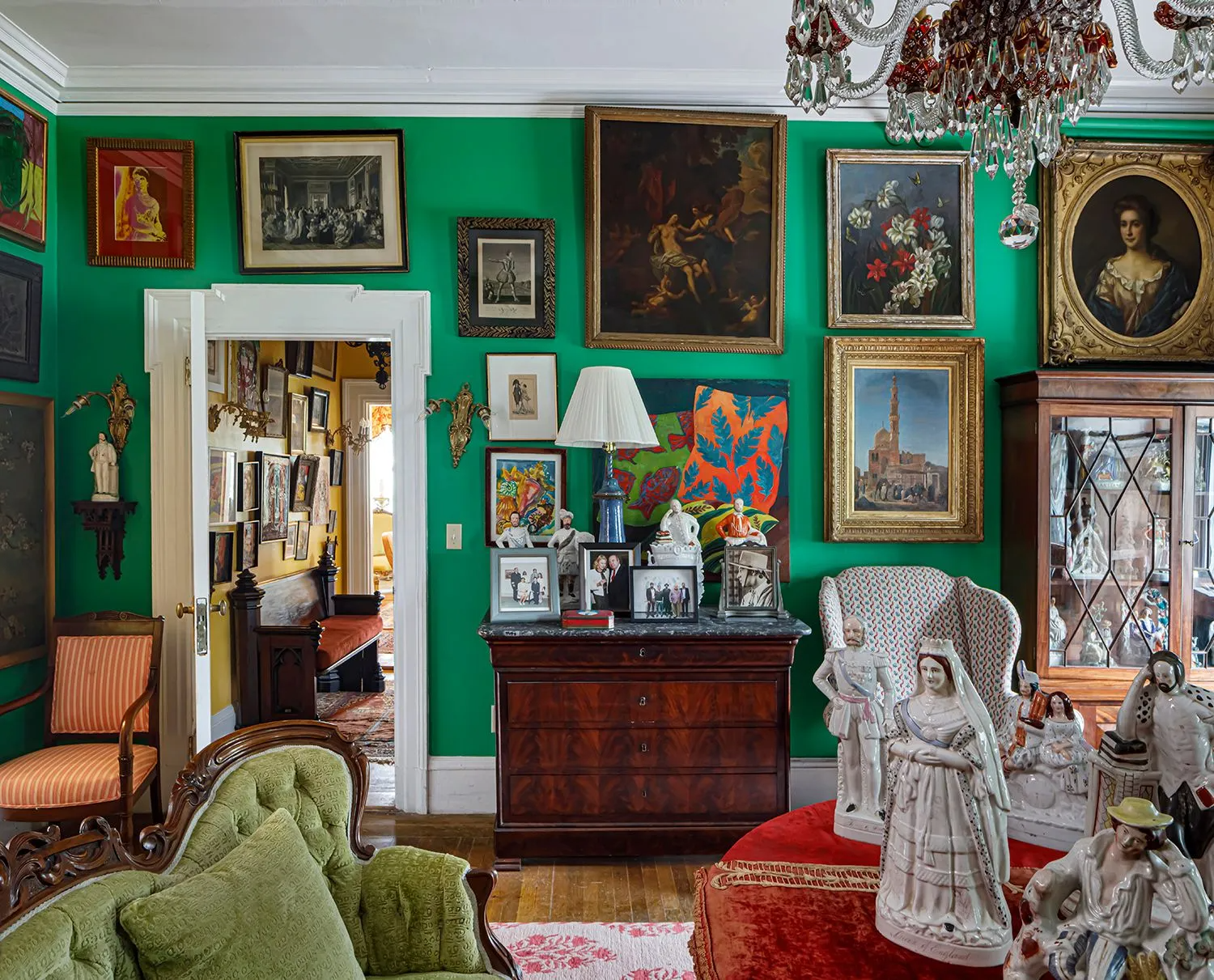 room with bright green walls and lots of artwork on the walls