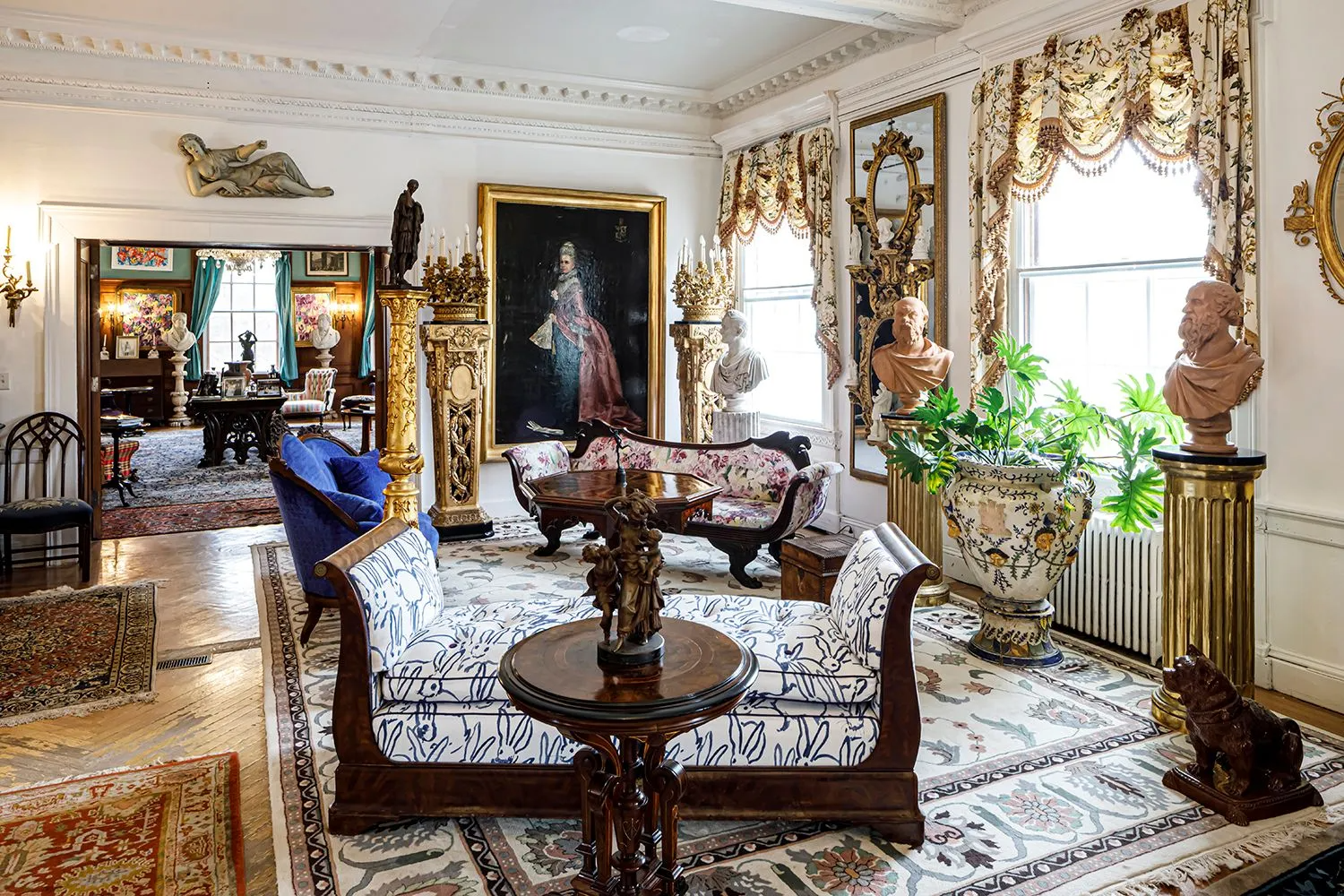 grand entry hall with multiple seating areas, plasterwork, wood floor