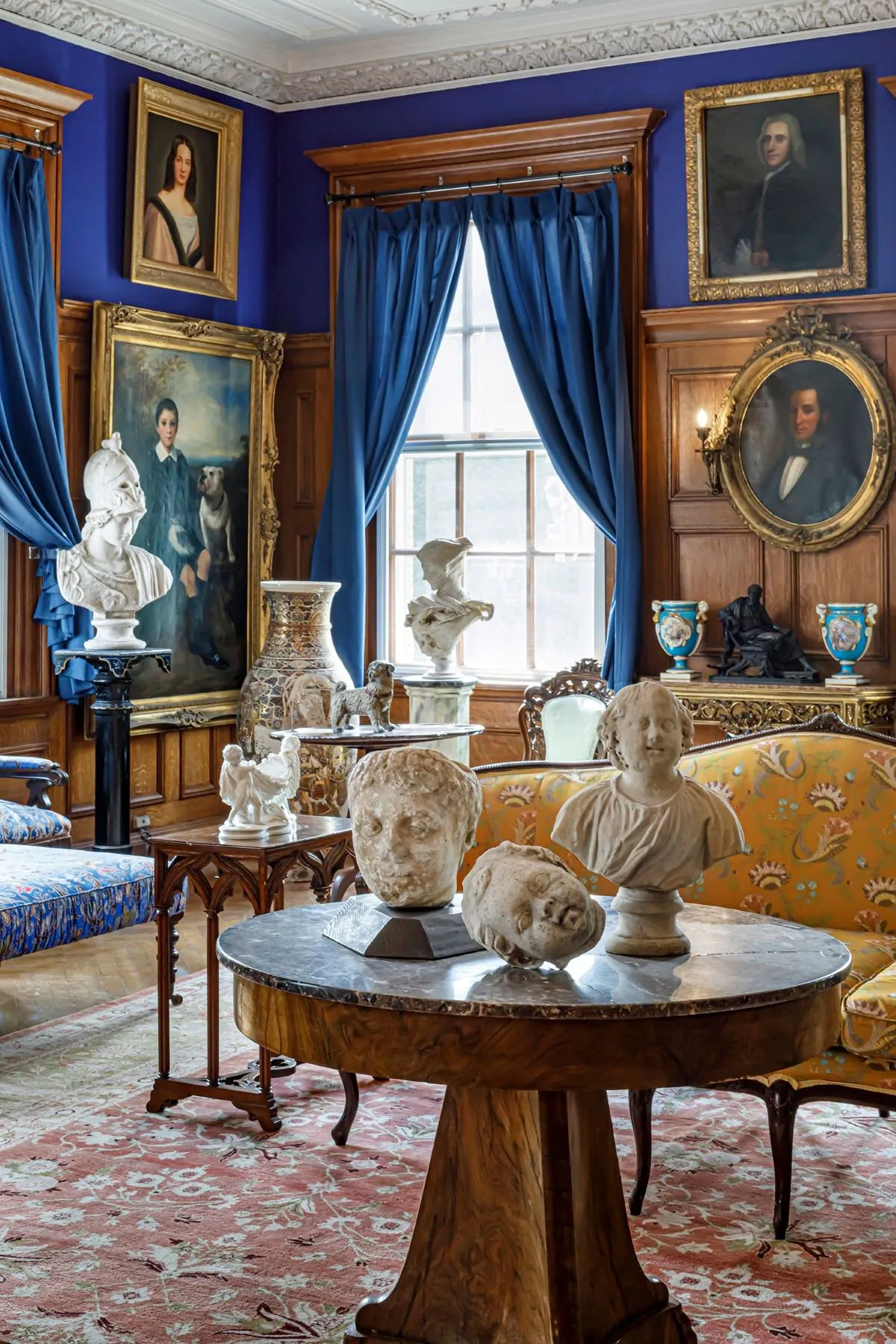 parlor with wainscoting, bright blue walls, plasterwork