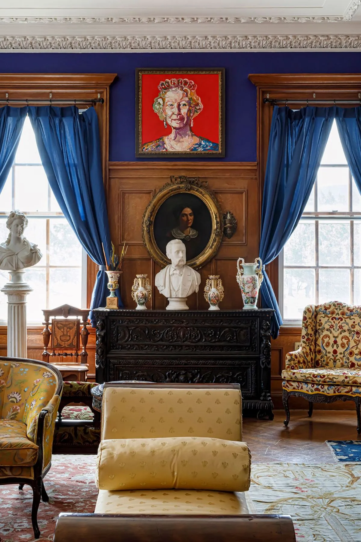 parlor with wainscoting, bright blue walls, plasterwork
